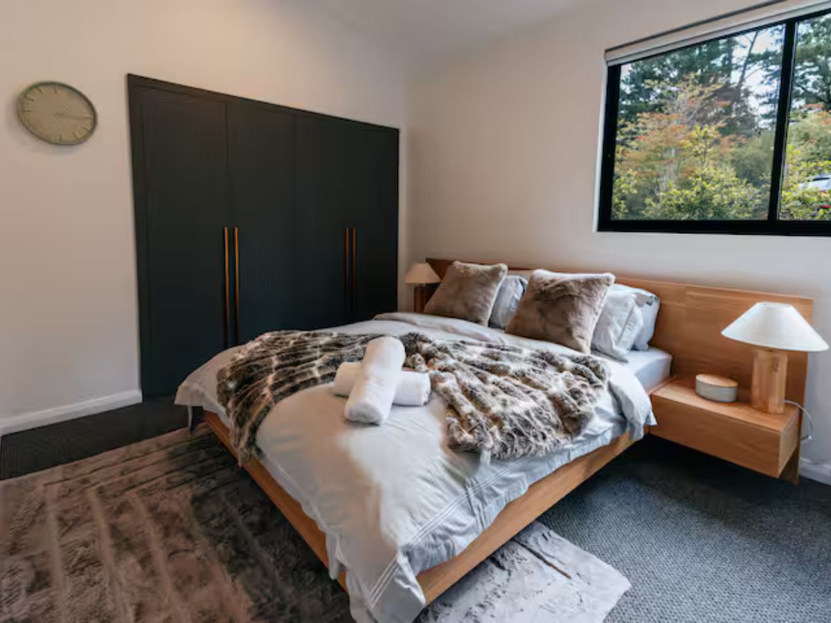 Warm timber bedroom at Rustic Pine Escape with premium linens