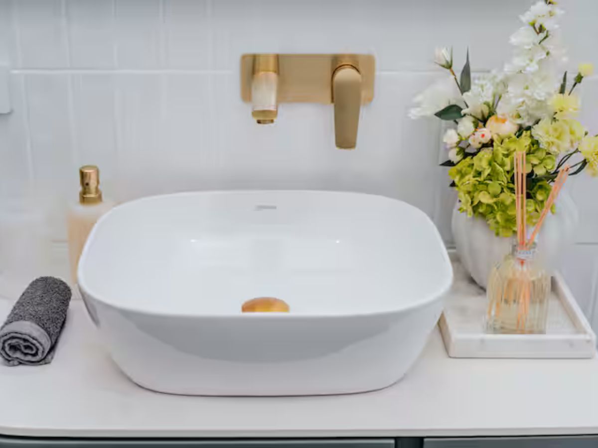 Bathroom sink detail with warm finishes and thoughtful styling